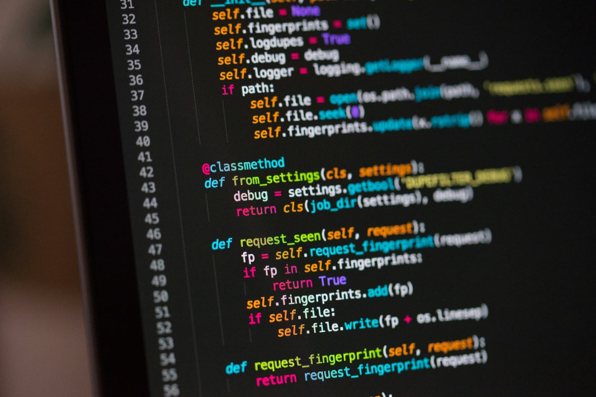 Python source code on a monitor representing ThreatBlock digital intelligence and cyber threat analysis